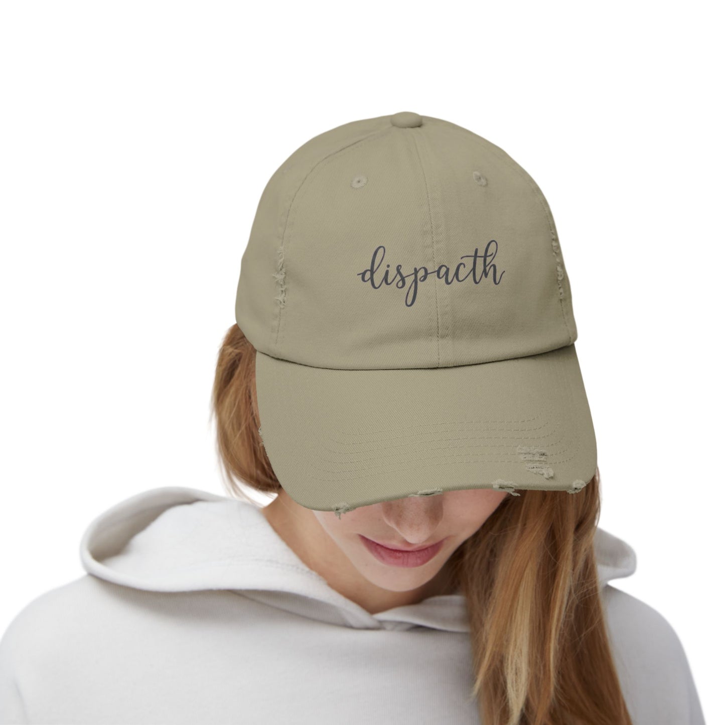Person wearing a beige cap with a logo on a white background