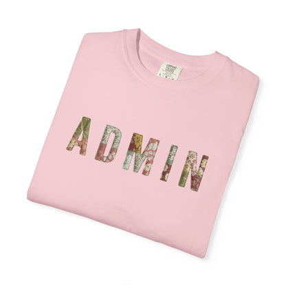 Folded pink t-shirt with 'ADMIN' printed in colorful letters on a white background