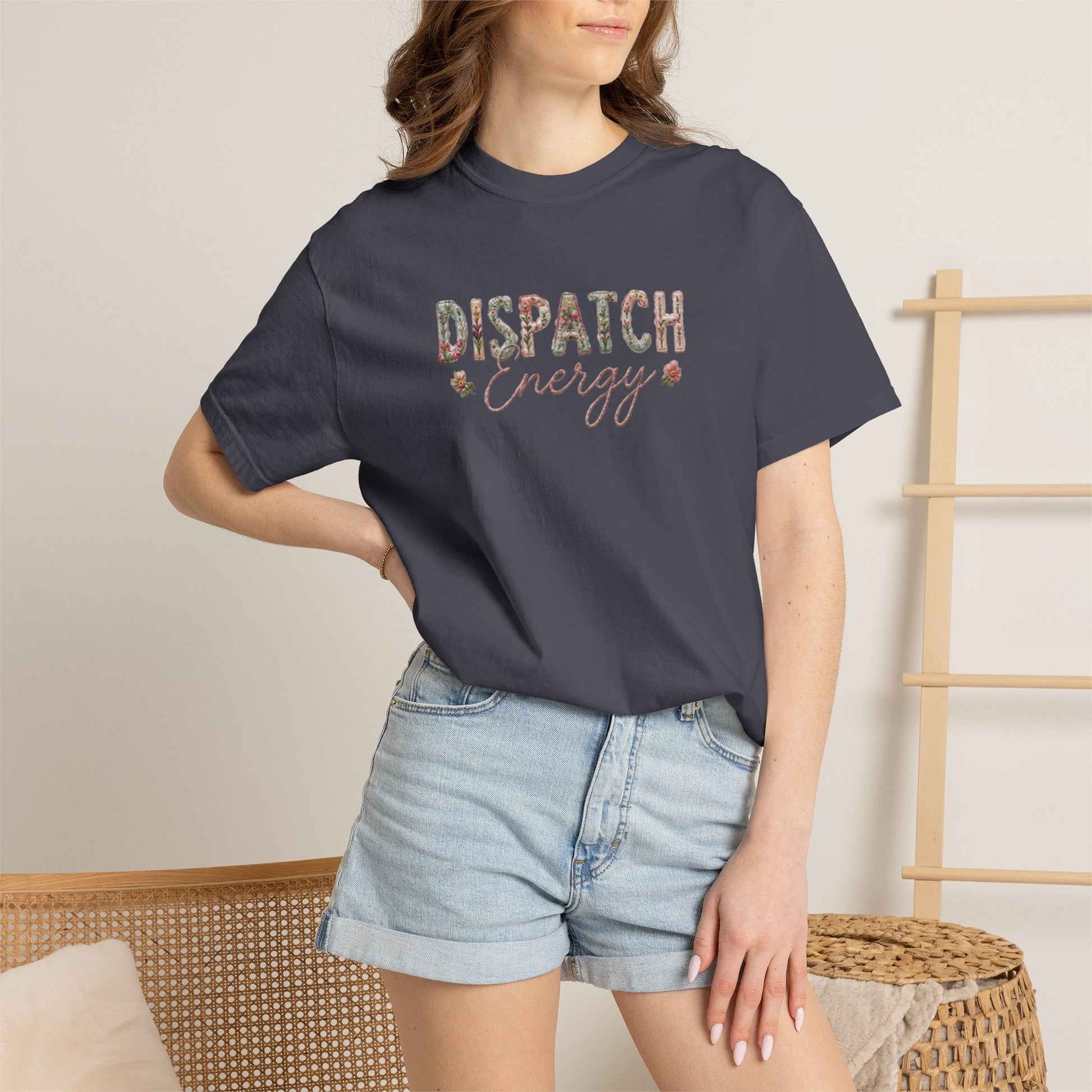 Person wearing a NAVY BLUE t-shirt with 'DISPATCH ENERGY' text and denim shorts indoors.