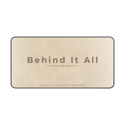 Beige mat with 'Behind It All' text on a white background