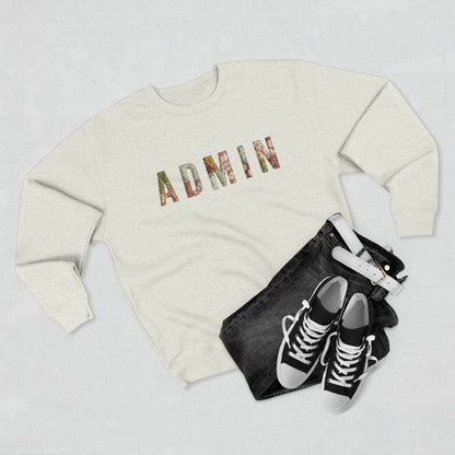 White SWEATSHIRT with 'ADMIN' text on a neutral surface with beige pants and decorative items.