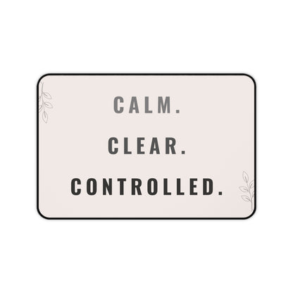 Decorative mat with 'CALM. CLEAR. CONTROLLED.' text on a light pink background