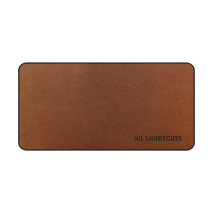 Brown desk mat with 'NO SHORTCUTS' text on a white background