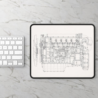 Engine blueprint on a tablet with a keyboard on a marble surface