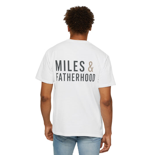 Person wearing a white t-shirt with 'MILES & FATHERHOOD' text on the back against a white background