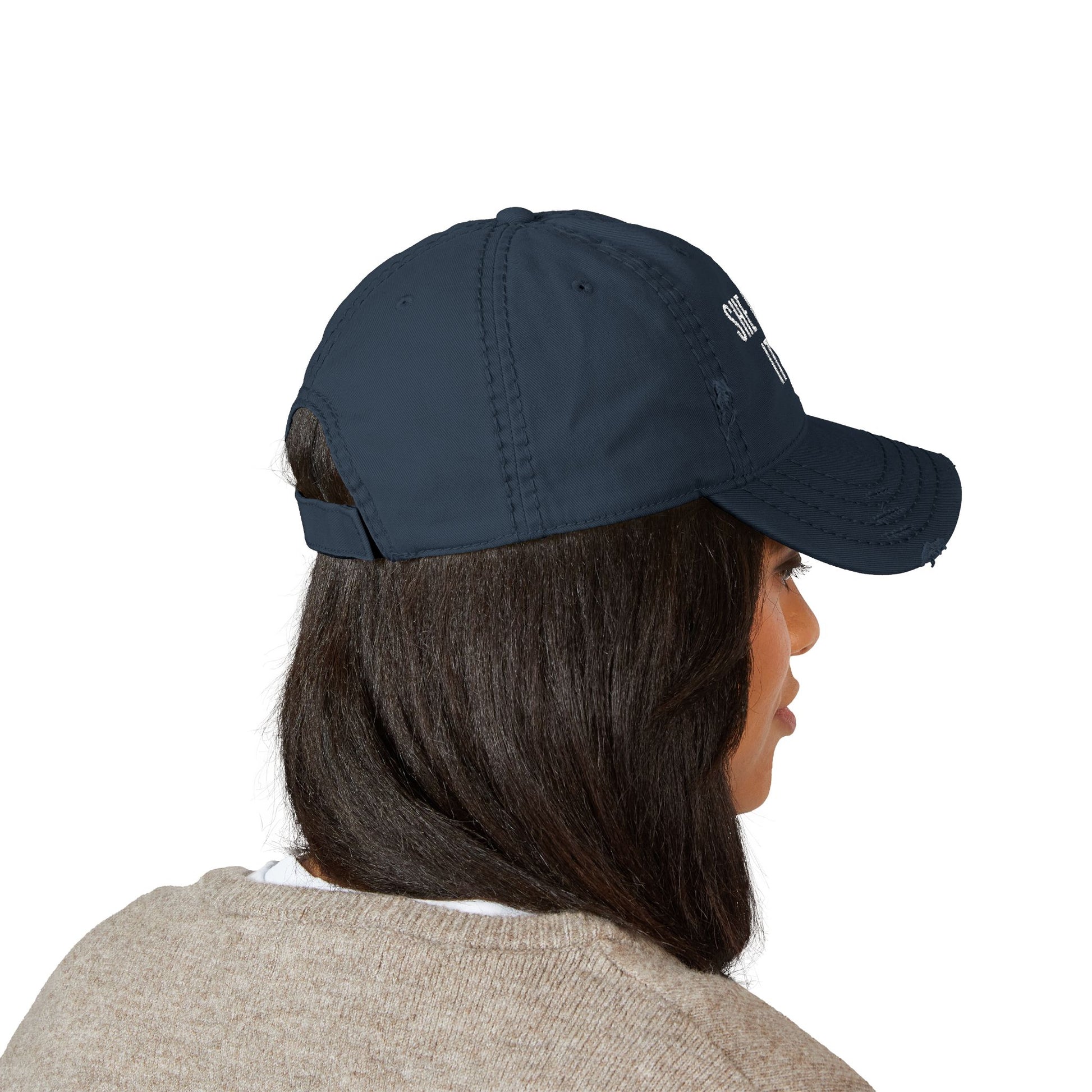 Person wearing a navy blue cap on a white background