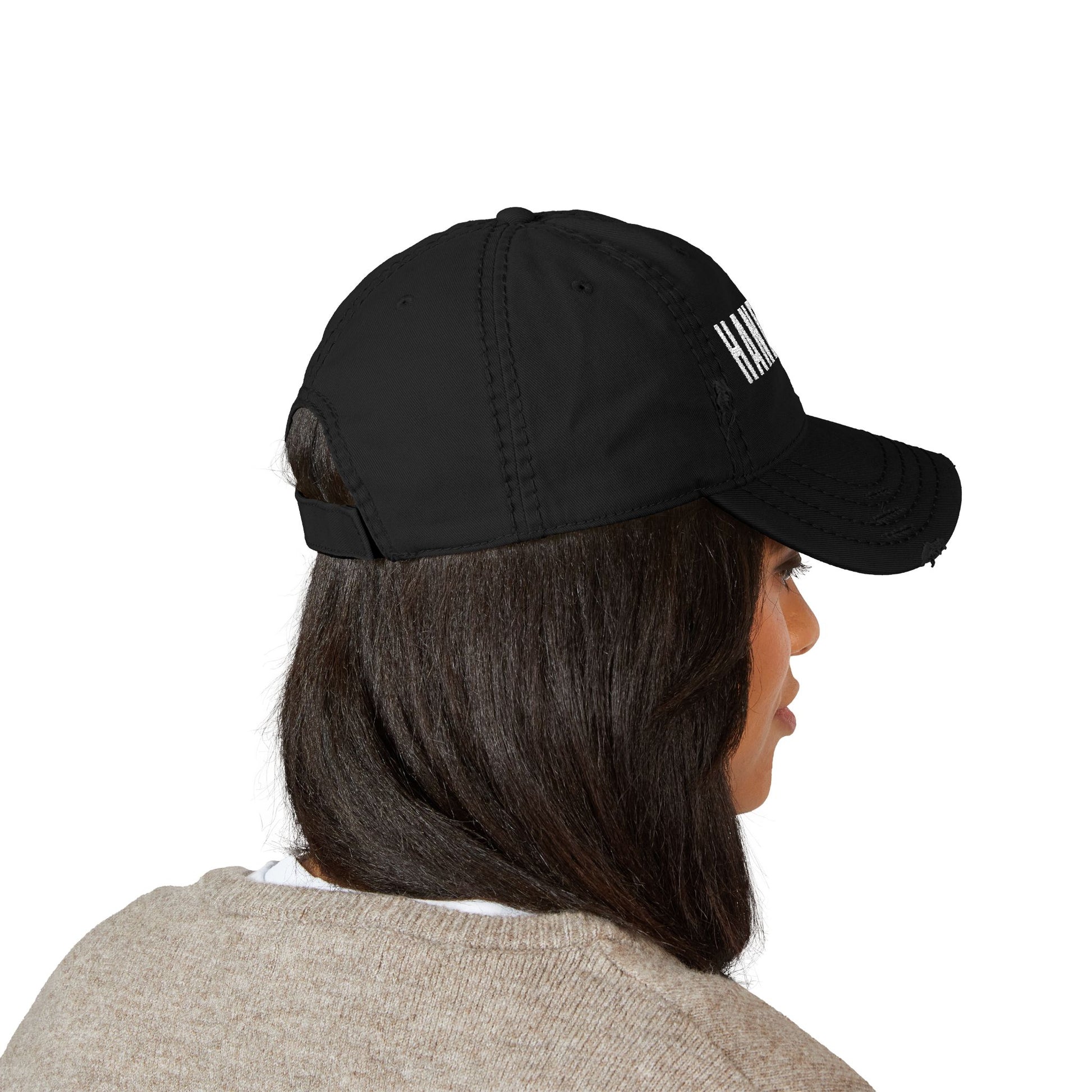 Person wearing a black cap with text on a white background