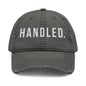 Gray cap with 'HANDLED.' text on a white background