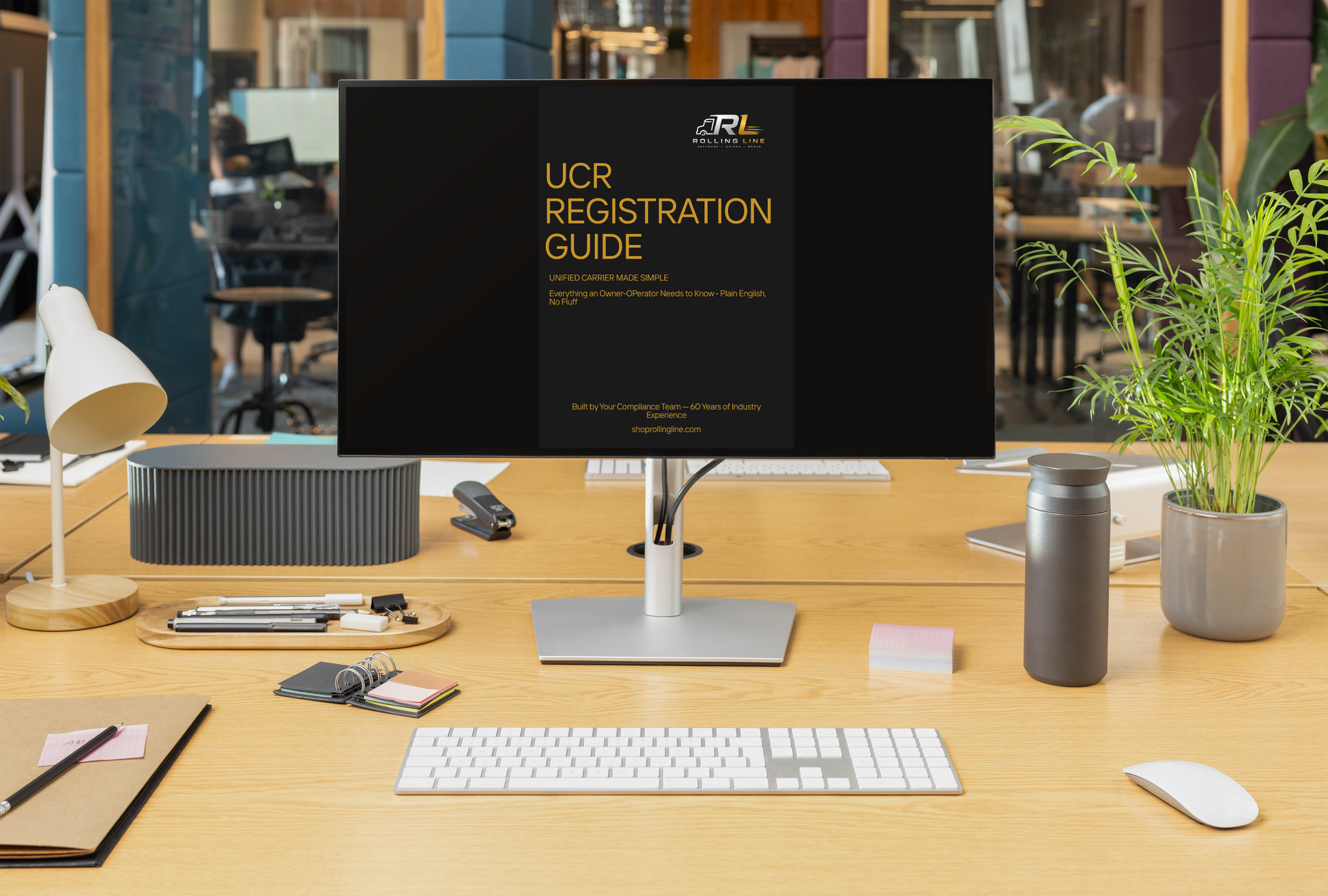 Computer monitor displaying 'UCR Registration Guide' on a desk with office items.