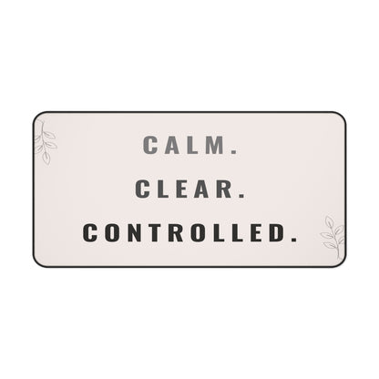 Rectangular sign with 'CALM. CLEAR. CONTROLLED.' text on a light pink background
