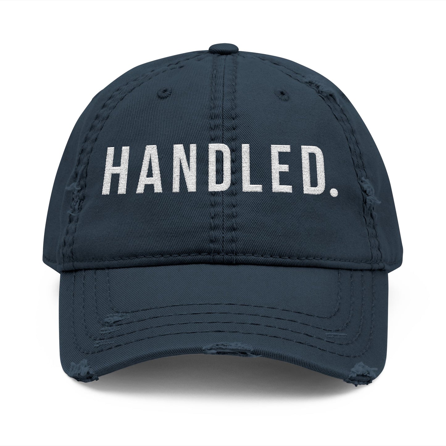 Navy blue cap with 'HANDLED.' text on a white background