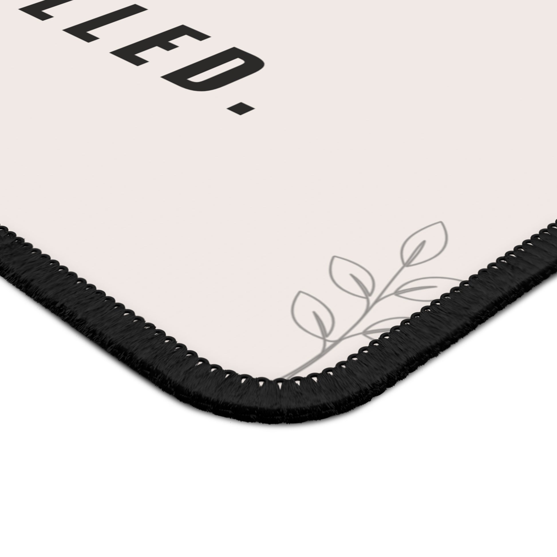 Corner of a product packaging with text and leaf design on a white background