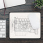 Engine diagram on a mouse pad with a keyboard and plant in the background