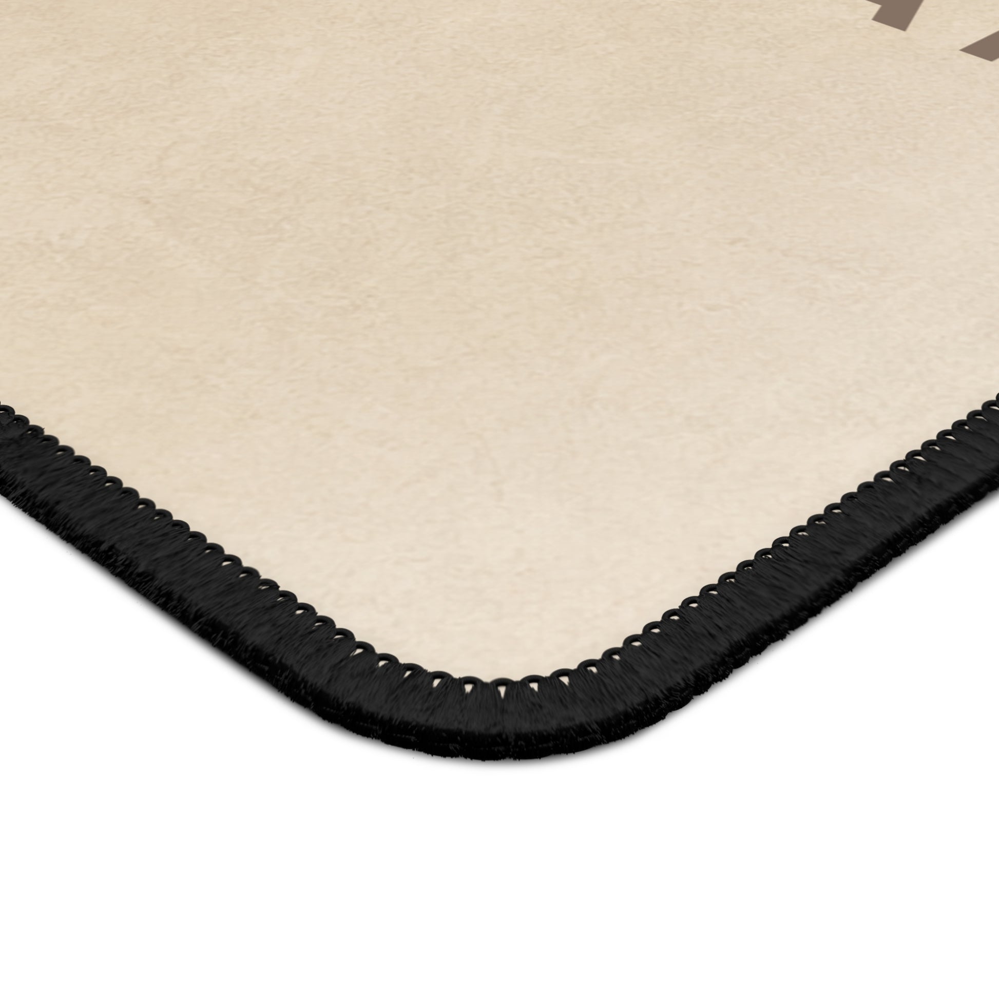 Beige rug with black border on a white background
