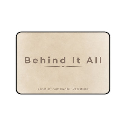 Beige mat with 'Behind It All' text on a white background