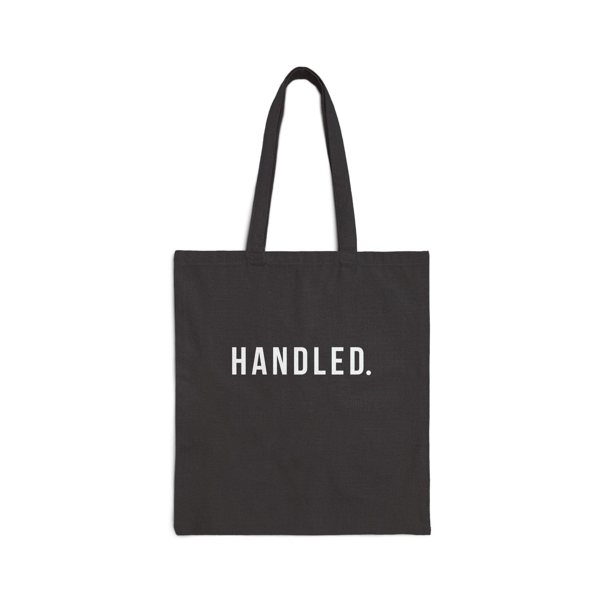 Black tote bag with white text on a white background