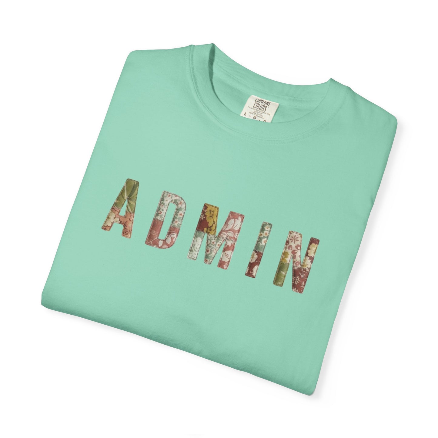 Folded mint green t-shirt with 'ADMIN' printed in colorful letters on a white background