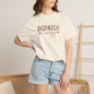 Person wearing a white t-shirt with 'DISPATCH ENERGY' text and denim shorts indoors.
