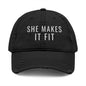Gray cap with 'SHE MAKES IT FIT' text on a white background