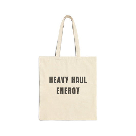Beige tote bag with 'HEAVY HAUL ENERGY' text on a white background