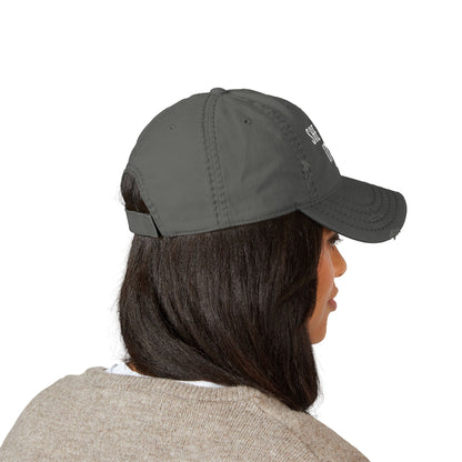 Person wearing a green baseball cap on a white background