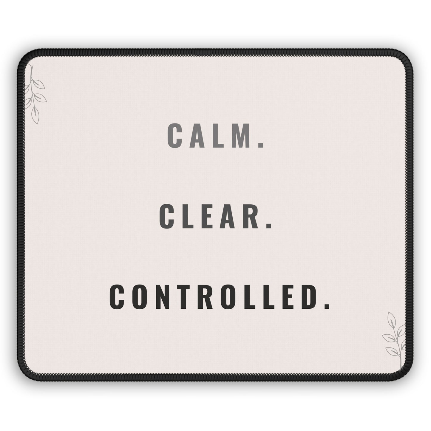 Mouse pad with motivational text 'CALM. CLEAR. CONTROLLED.' on a light background