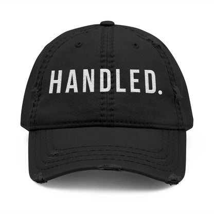 Black cap with 'HANDLED.' text on a white background