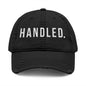 Black cap with 'HANDLED.' text on a white background