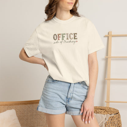 Person wearing a white t-shirt with text and denim shorts in a casual setting