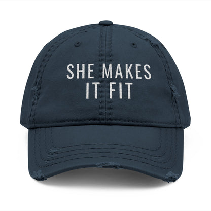 Gray cap with 'SHE MAKES IT FIT' text on a white background