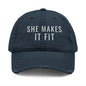 Gray cap with 'SHE MAKES IT FIT' text on a white background