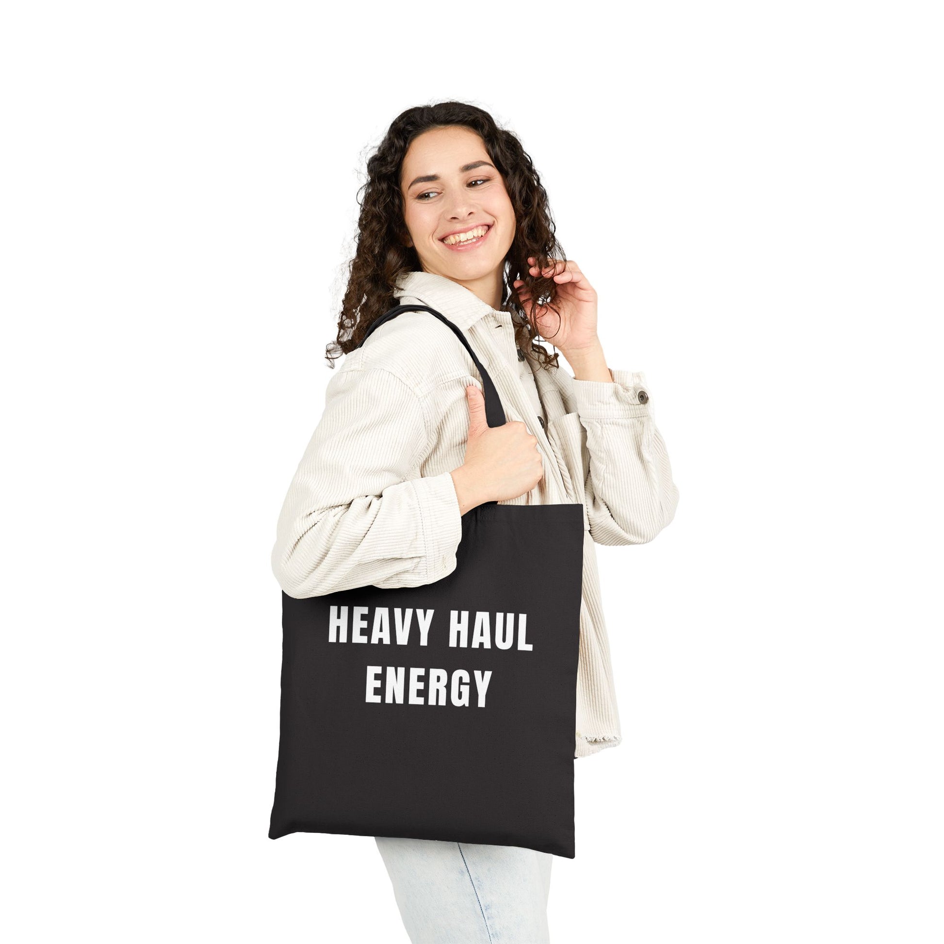 Woman holding a black tote bag with 'Finding Transylvania' design on a white background