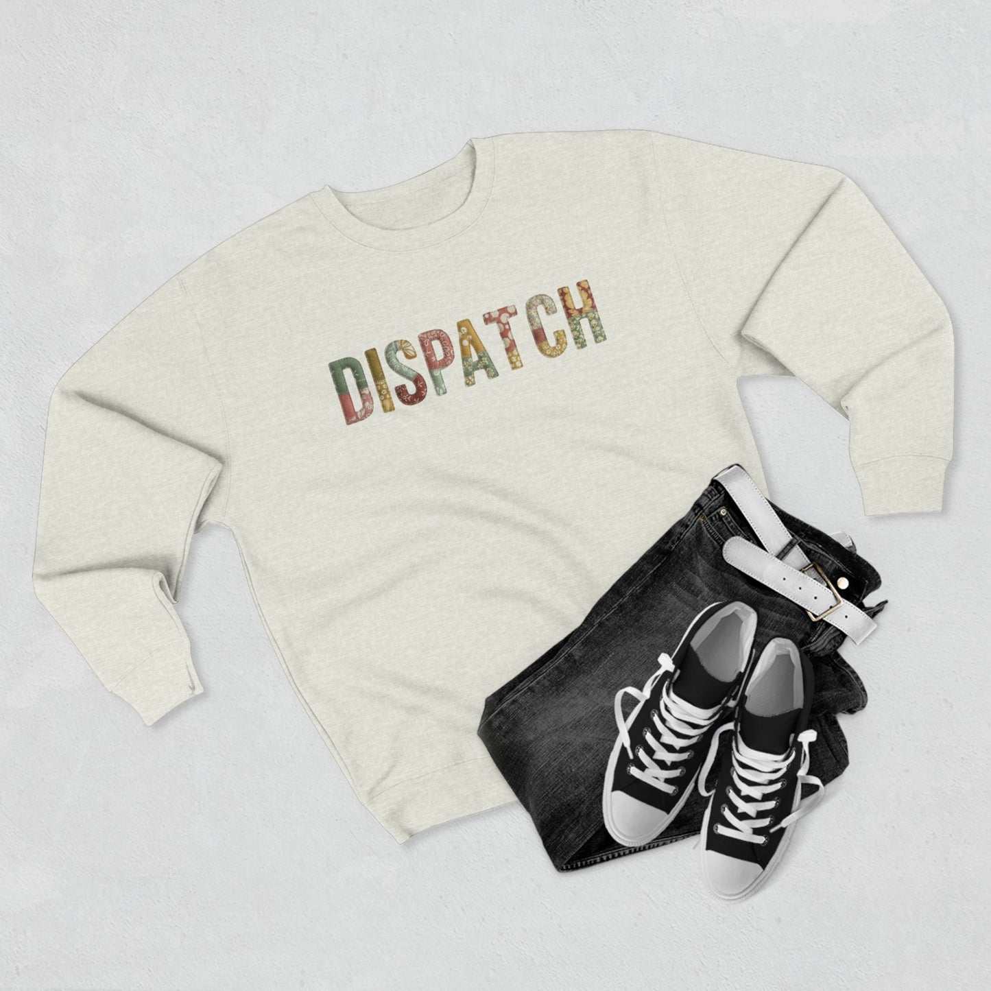 White sweatshirt with 'INDEPENDENT' text, black jeans, and black sneakers on a light gray background