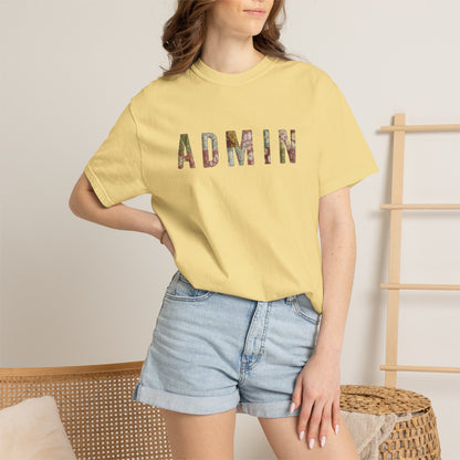 Person wearing a yellow t-shirt with 'ADMIN' printed on it, standing against a neutral background.