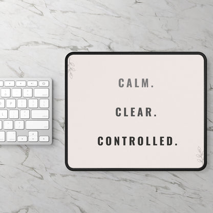 Tablet with 'CALM. CLEAR. CONTROLLED.' text on a marble surface with keyboard