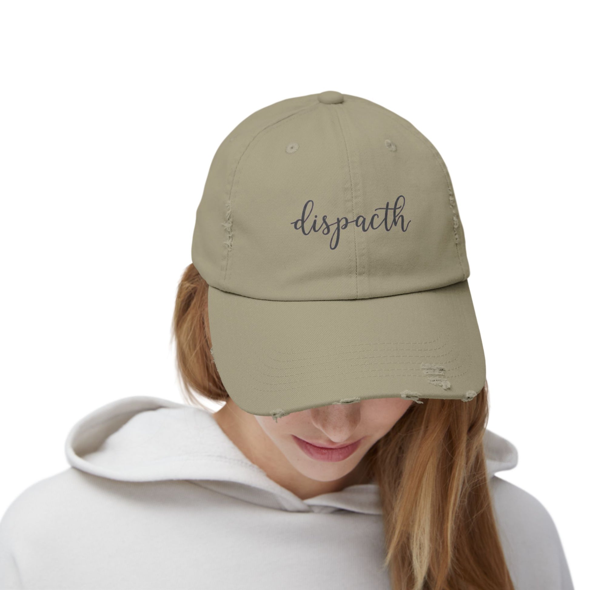 Person wearing a beige cap with a logo on a white background
